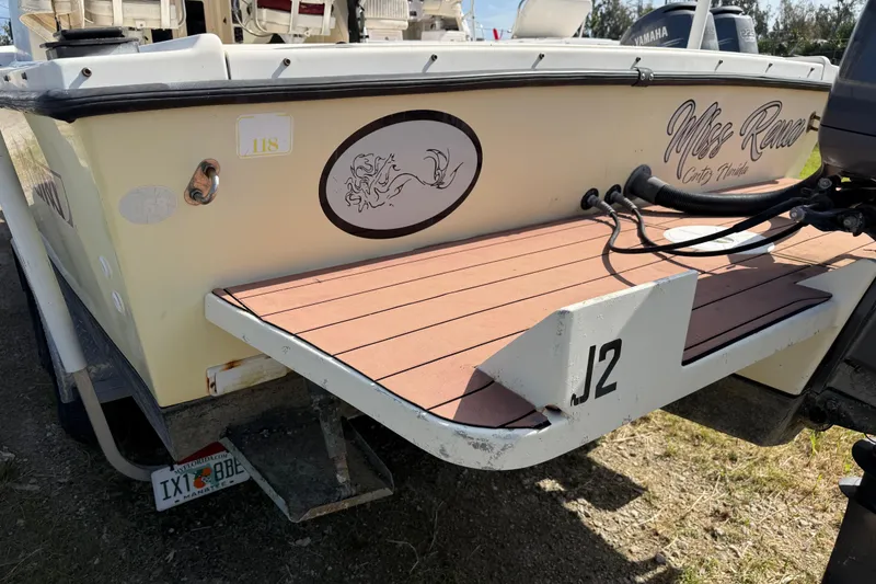 Slide: The Image of 2001 Parker 2510 Walkaround boat rear view with custom decals and swim platform. - 14
