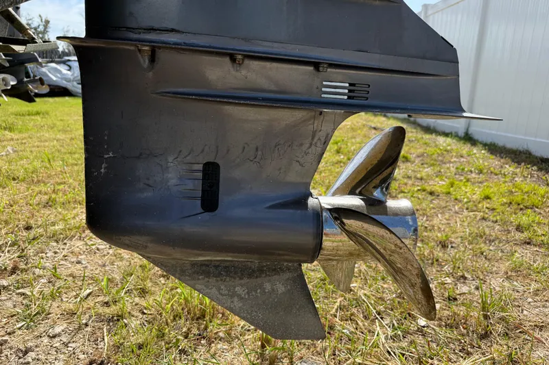 Slide: The Image of Close-up of a 2001 Parker 2510 Walkaround boat propeller on grassy ground. - 15