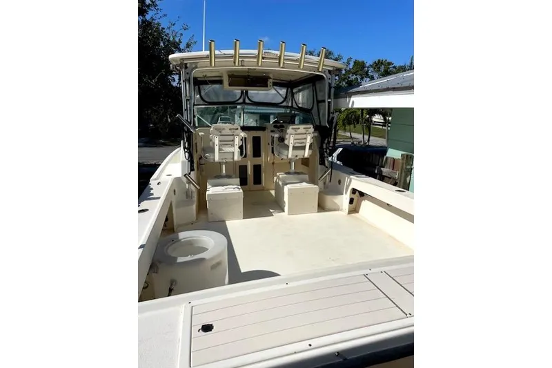 Slide: The Image of 2001 Parker 2510 Walkaround boat interior with seating and fishing rod holders. - 18