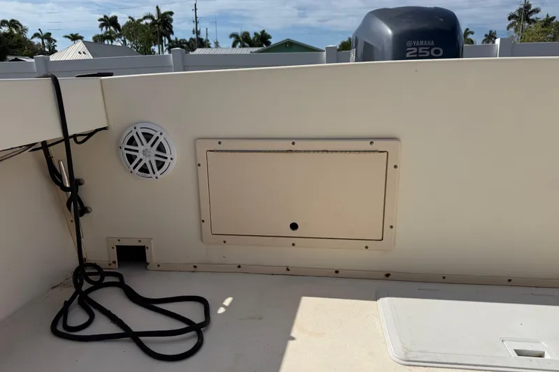Slide: The Image of 2001 Parker 2510 Walkaround boat interior with Yamaha 250 engine, speaker, and storage compartment. - 20