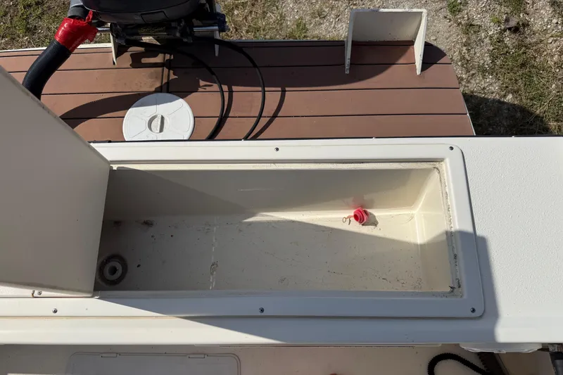 Slide: The Image of Open storage compartment on a 2001 Parker 2510 Walkaround boat deck. - 22