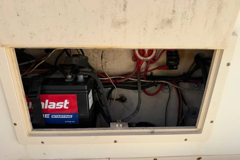 Slide: The Image of Battery compartment of a 2001 Parker 2510 Walkaround boat, showing wiring and connections. - 23