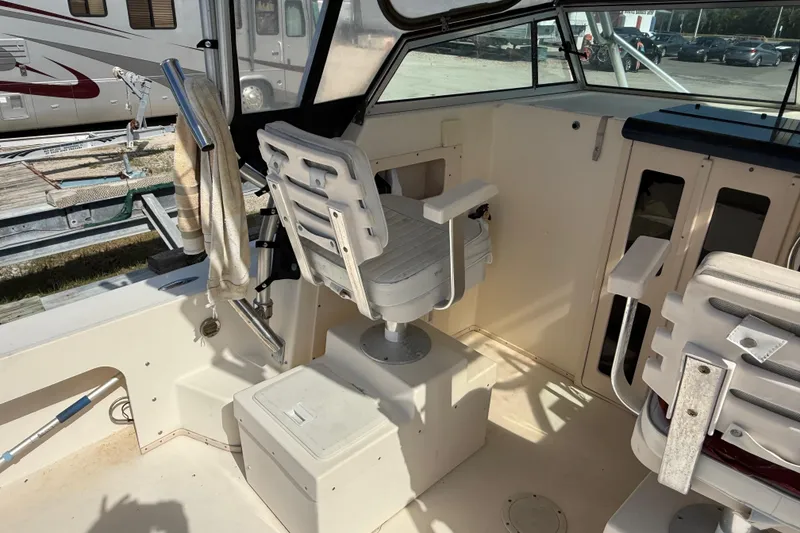 Slide: The Image of 2001 Parker 2510 Walkaround boat interior with seating and helm area. - 28