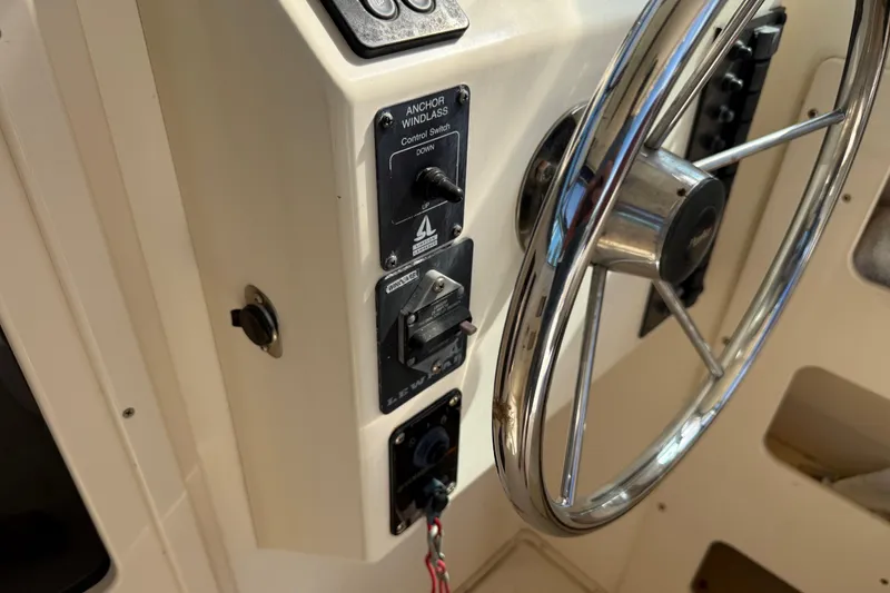 Slide: The Image of Steering wheel and controls of a 2001 Parker 2510 Walkaround boat. - 34