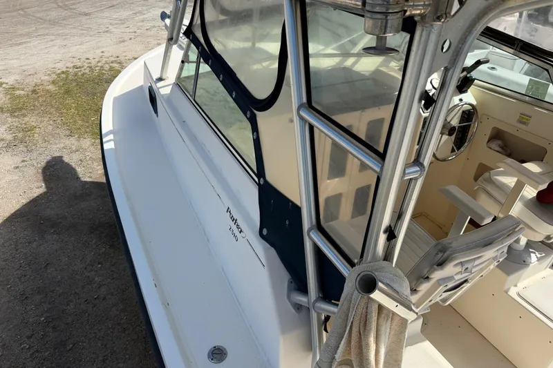 Slide: The Image of 2001 Parker 2510 Walkaround boat interior with steering wheel and seating. - 38