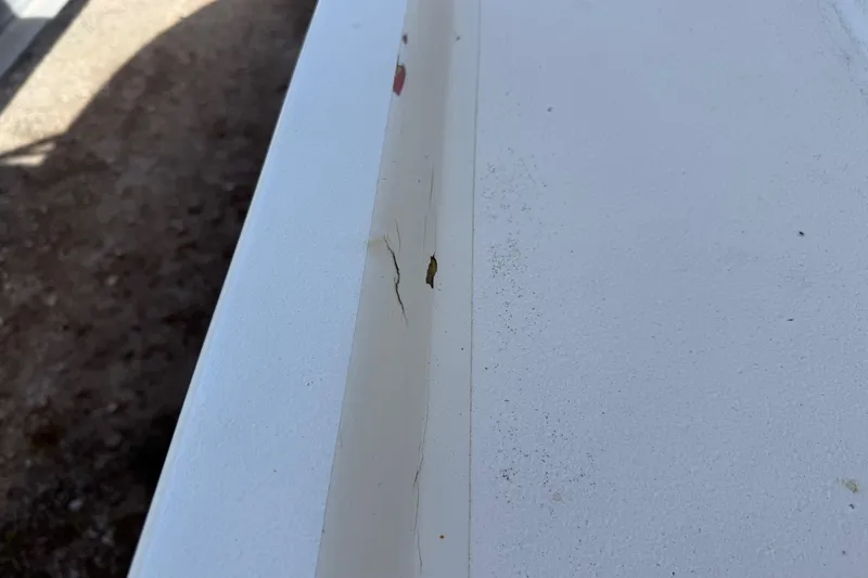 Slide: The Image of Close-up of a crack on a 2001 Parker 2510 Walkaround boat surface. - 39