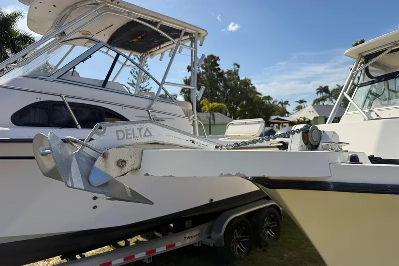 Slide: The Image of 2001 Parker 2510 Walkaround boat with Delta anchor, parked on a trailer. - 43
