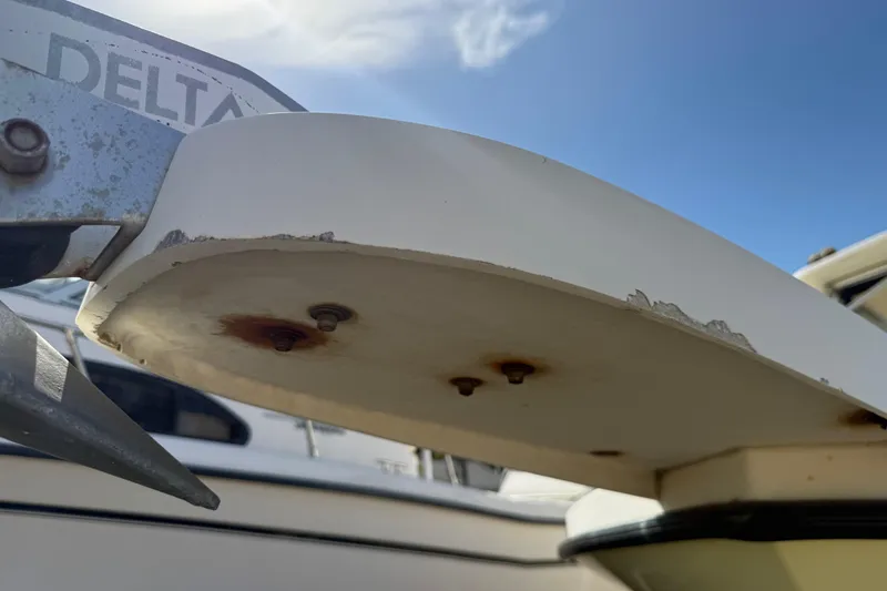 Slide: The Image of Close-up of a Parker 2510 Walkaround boat's anchor mount, showing rust and wear. - 44