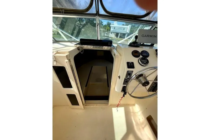 Slide: The Image of 2001 Parker 2510 Walkaround boat cockpit with Garmin navigation system and steering wheel. - 6