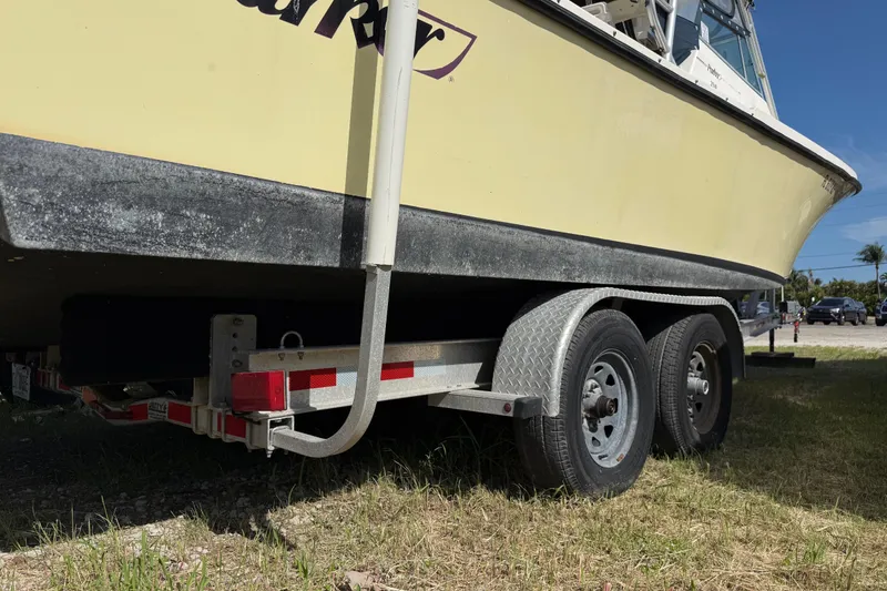 Slide: The Image of 2001 Parker 2510 Walkaround boat on trailer, parked on grass. - 9