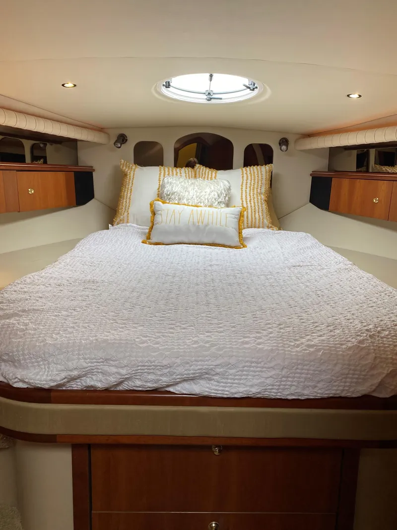 Slide: The Image of Luxurious bedroom in 2002 Cruisers Yachts 4270 Express with cozy bedding. - 10