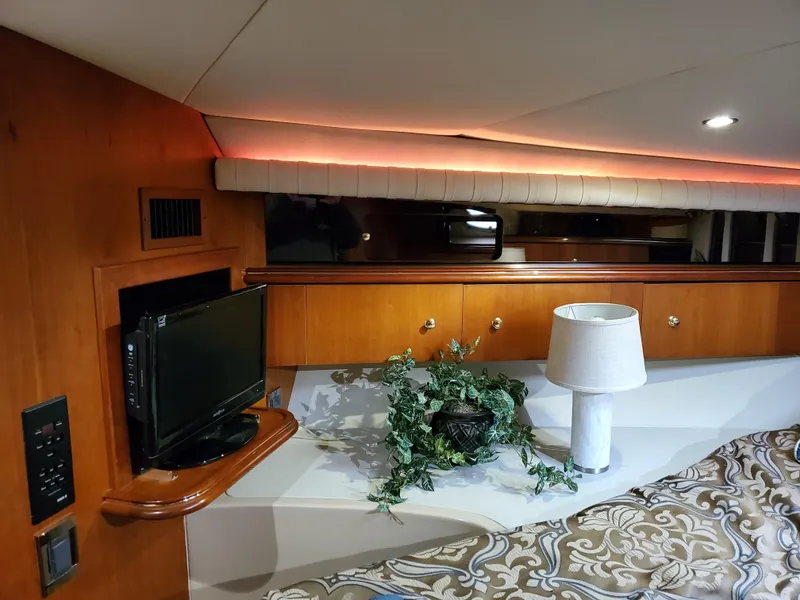 Slide: The Image of Interior of 2002 Cruisers Yachts 4270 Express with TV, lamp, and decor. - 12