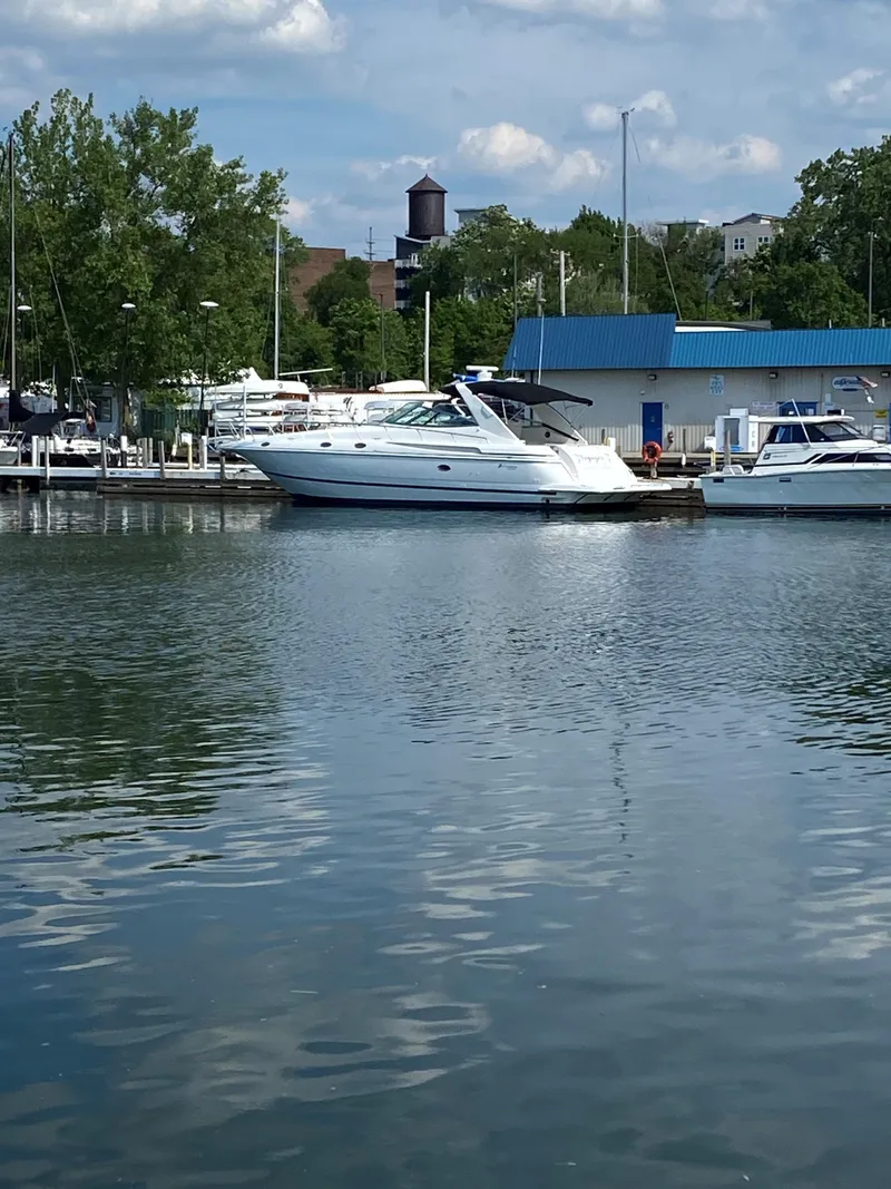 Slide: The Image of 2002 Cruisers Yachts 4270 Express docked at a marina. - 2