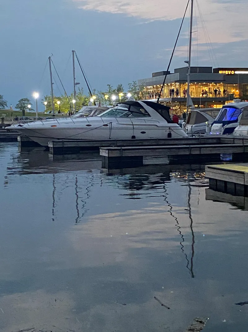 Slide: The Image of 2002 Cruisers Yachts 4270 Express docked at a marina during twilight. - 3