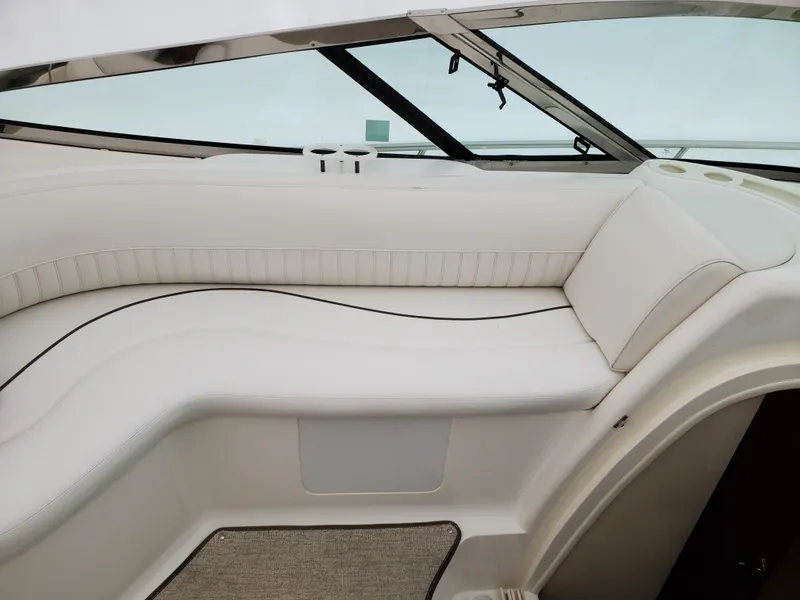 Slide: The Image of 2002 Cruisers Yachts 4270 Express interior seating with white upholstery and panoramic windows. - 6
