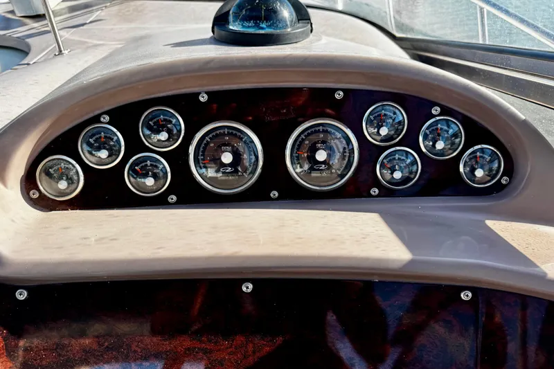 Slide: The Image of Dashboard of a 2004 Regal Commodore 3860 boat with multiple gauges. - 13