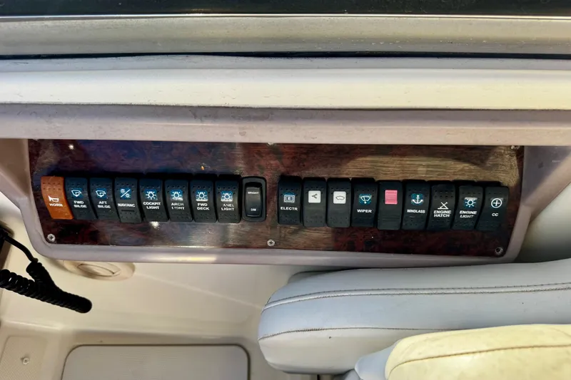 Slide: The Image of Control panel of a 2004 Regal Commodore 3860 boat with labeled switches. - 14