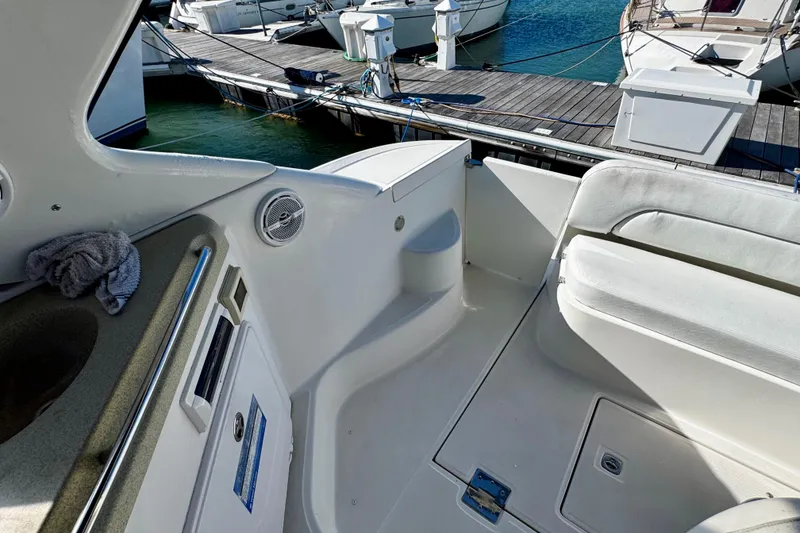 Slide: The Image of 2004 Regal Commodore 3860 yacht interior with seating, docked at marina. - 21
