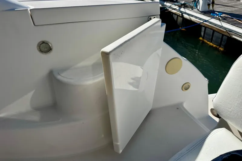 Slide: The Image of 2004 Regal Commodore 3860 boat interior with open storage compartment near dock. - 22