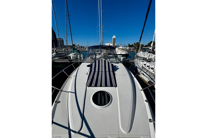 Slide: The Image of 2004 Regal Commodore 3860 yacht docked in a marina under clear blue skies. - 28