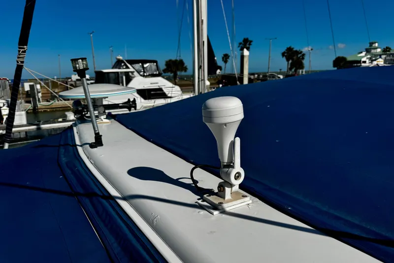 Slide: The Image of 2004 Regal Commodore 3860 yacht with blue cover docked at marina. - 31