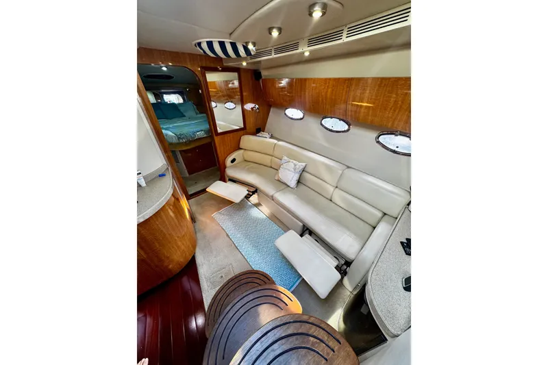 Slide: The Image of Interior of 2004 Regal Commodore 3860 yacht with leather seating and wood accents. - 35