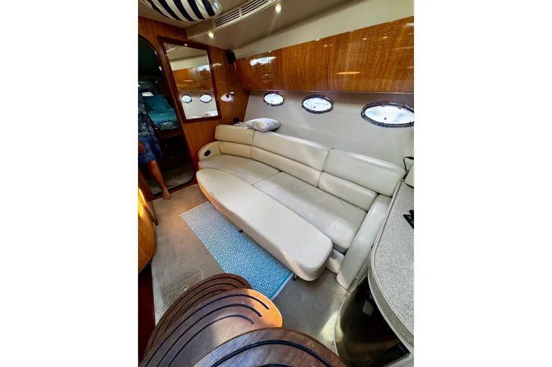 Slide: The Image of Luxurious interior of 2004 Regal Commodore 3860 yacht with plush seating and elegant wood finishes. - 36
