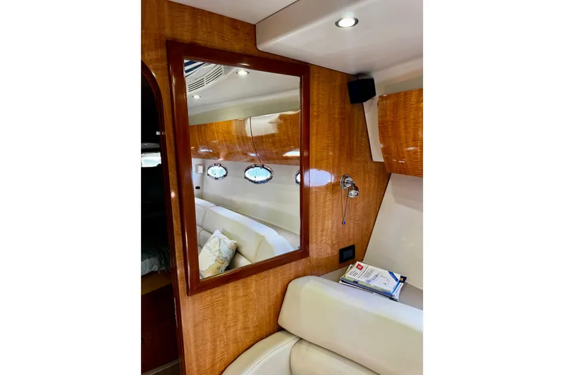 Slide: The Image of Interior of 2004 Regal Commodore 3860 yacht with wood paneling and seating area. - 39