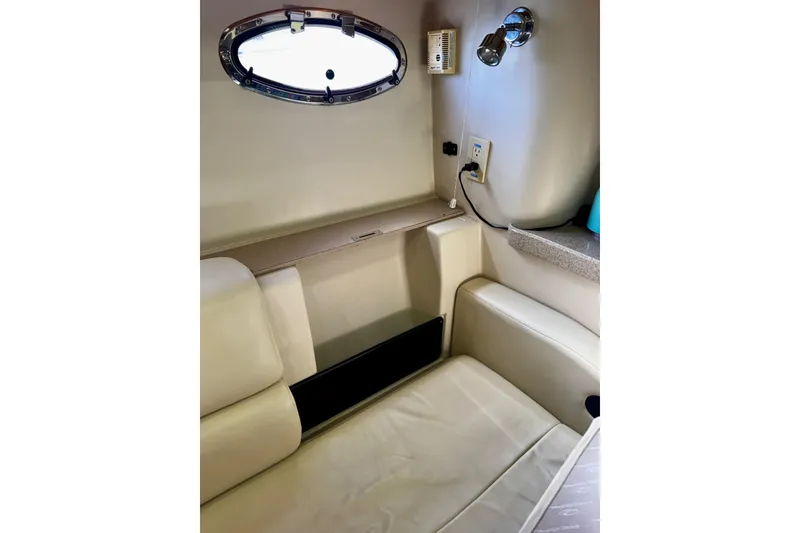 Slide: The Image of Interior of 2004 Regal Commodore 3860 yacht with seating and porthole window. - 42