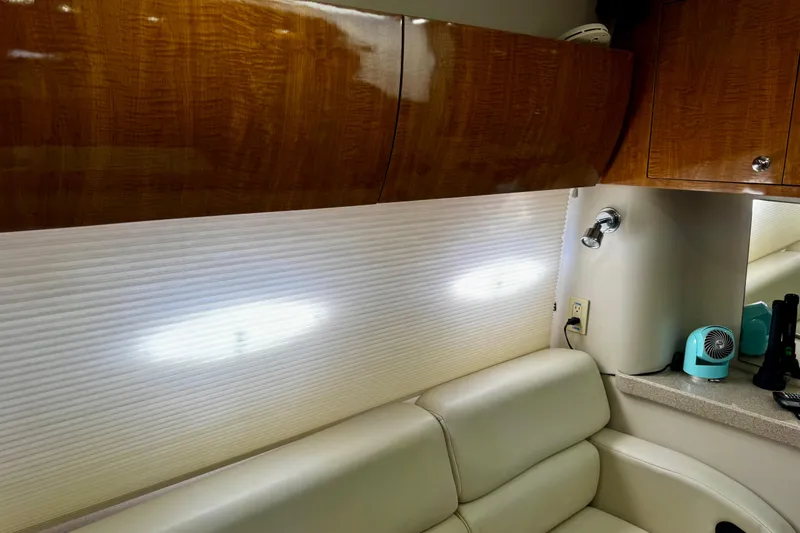 Slide: The Image of Interior of 2004 Regal Commodore 3860 yacht with leather seating and wooden cabinetry. - 43