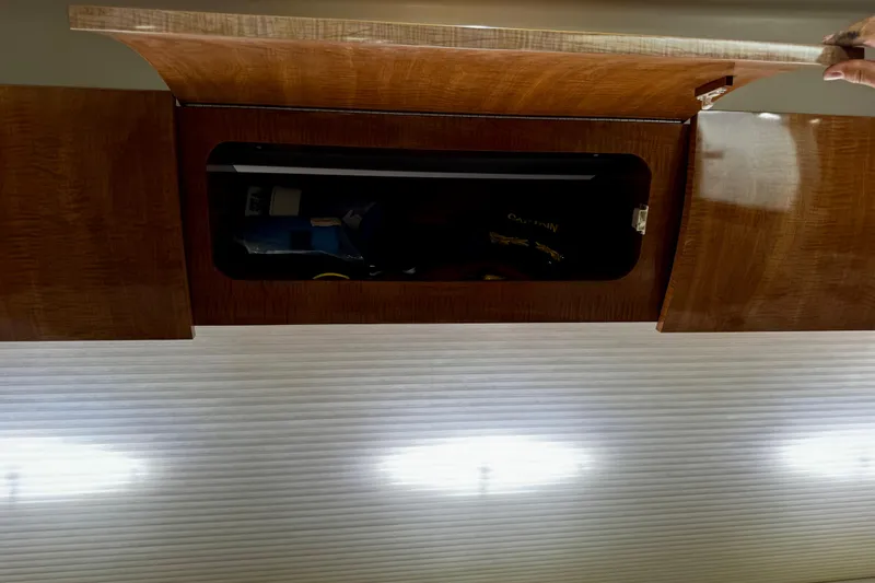 Slide: The Image of Open wooden cabinet in a 2004 Regal Commodore 3860 boat interior. - 44