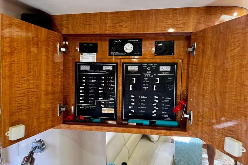Slide: The Image of Electrical control panel inside 2004 Regal Commodore 3860 yacht, featuring various switches and gauges. - 45