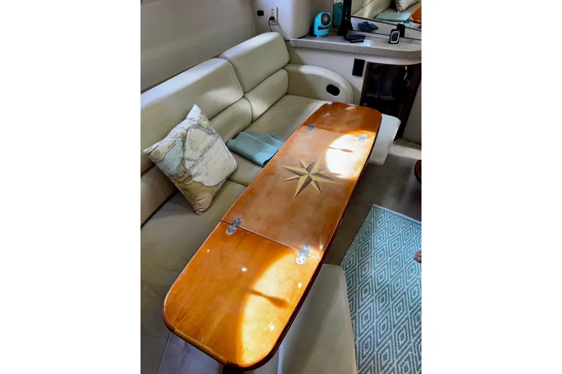 Slide: The Image of Luxurious interior of 2004 Regal Commodore 3860 yacht with wooden table and plush seating. - 47