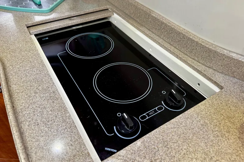 Slide: The Image of Built-in stovetop on 2004 Regal Commodore 3860 yacht, featuring dual burners. - 49