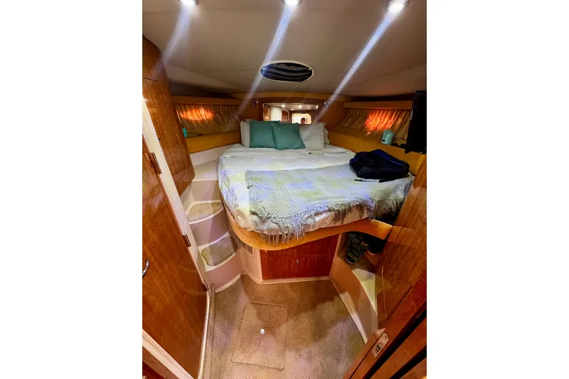 Slide: The Image of Interior cabin of 2004 Regal Commodore 3860 yacht with cozy bed and ambient lighting. - 54