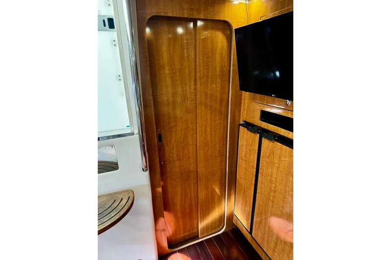 Slide: The Image of 2004 Regal Commodore 3860 interior with wood paneling and mounted TV. - 60