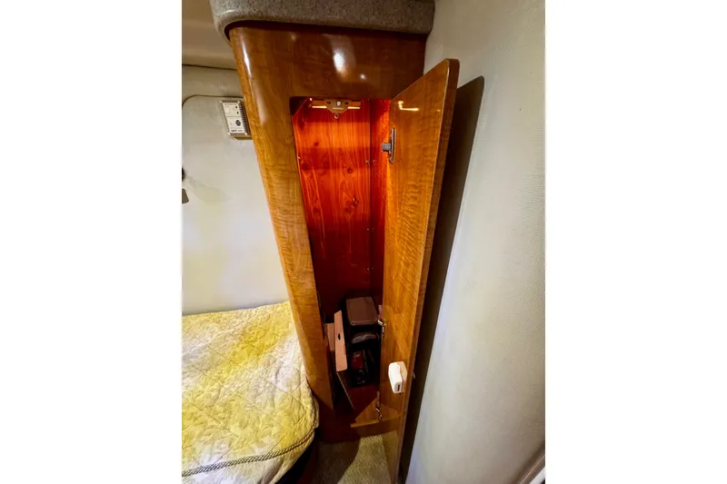Slide: The Image of 2004 Regal Commodore 3860 interior with open wooden cabinet and bed corner. - 63