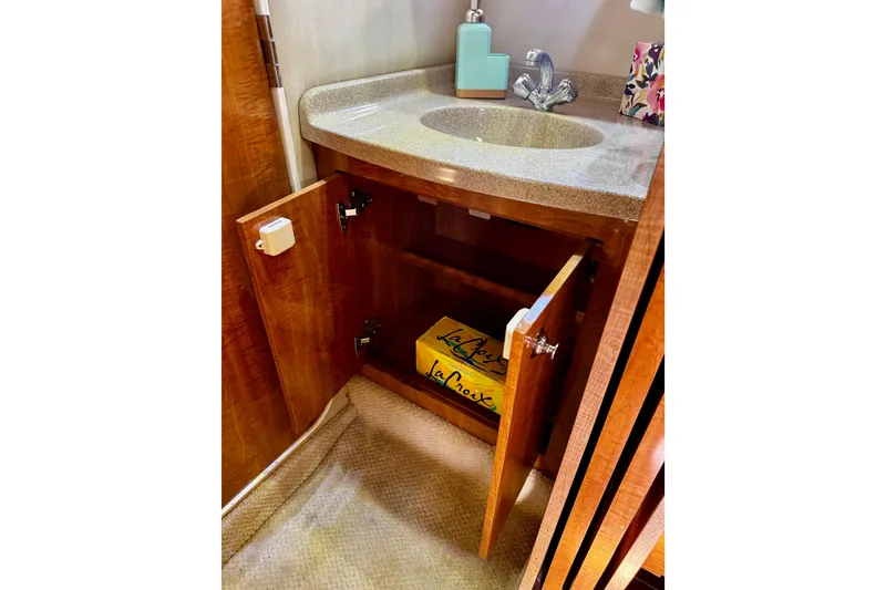 Slide: The Image of Bathroom sink cabinet in 2004 Regal Commodore 3860 yacht with open storage. - 65
