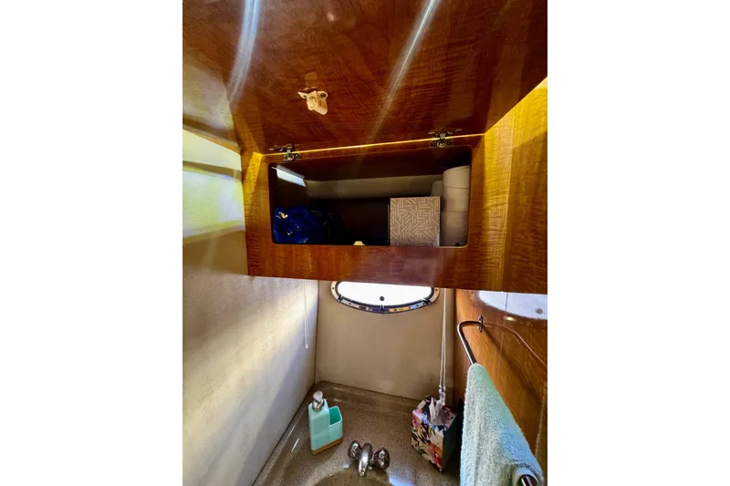 Slide: The Image of 2004 Regal Commodore 3860 bathroom cabinet with toiletries and towel. - 66