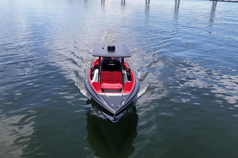 Slide: The Image of 2026 Nor-Tech 340 Sport Center Console boat cruising on calm water. - 14