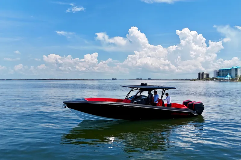 Slide: The Image of 2026 Nor-Tech 340 Sport Center Console boat on calm water under blue sky. - 2