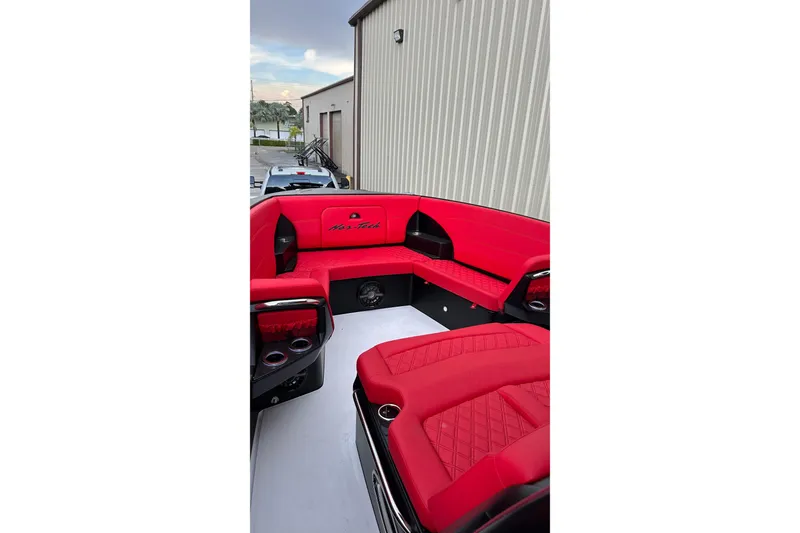 Slide: The Image of 2026 Nor-Tech 340 Sport Center Console with vibrant red seating and sleek design. - 26
