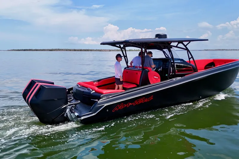 Slide: The Image of 2026 Nor-Tech 340 Sport Center Console boat cruising on calm waters. - 6