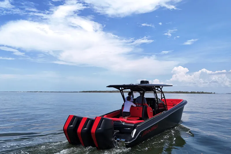 Slide: The Image of 2026 Nor-Tech 340 Sport Center Console cruising on calm waters under a clear sky. - 7