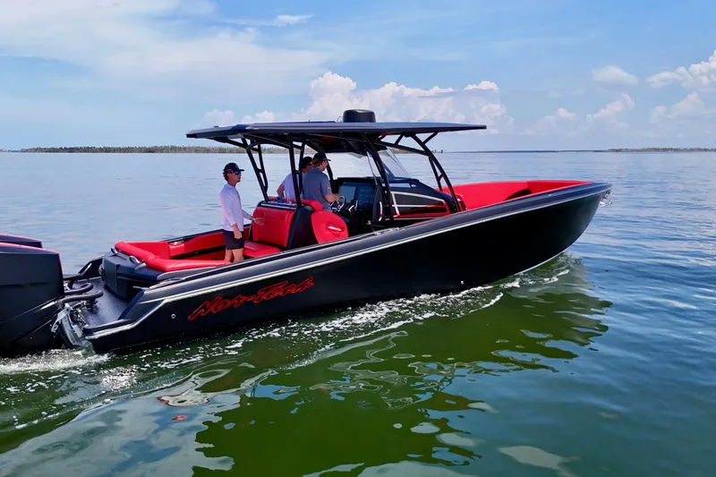 Slide: The Image of 2026 Nor-Tech 340 Sport Center Console boat cruising on calm waters under a clear sky. - 8