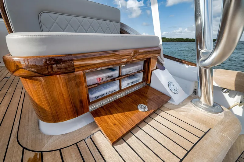 Slide: The Image of Luxurious 2022 Winter Custom Yachts 38 Walk Around with elegant wood finish and storage compartments. - 18