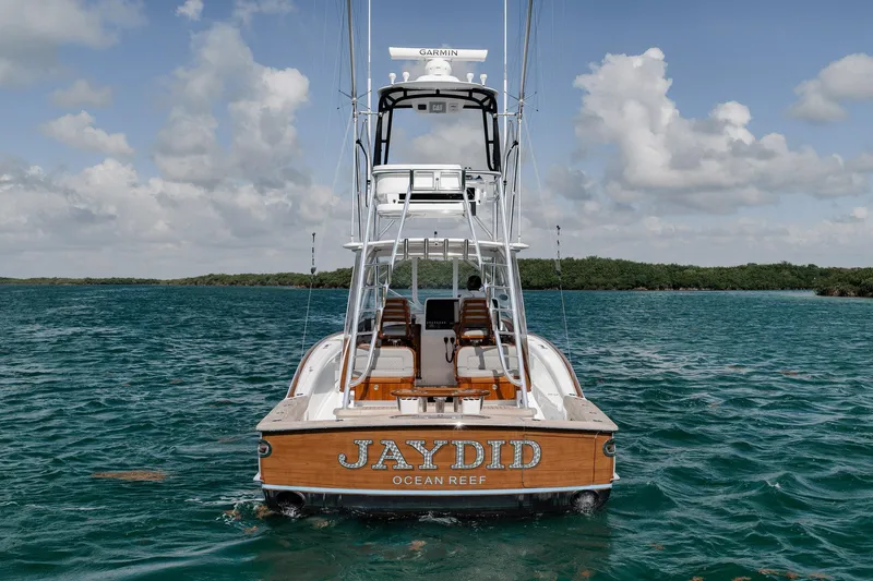 Slide: The Image of 2022 Winter Custom Yachts 38 Walk Around on water, rear view, clear sky. - 2