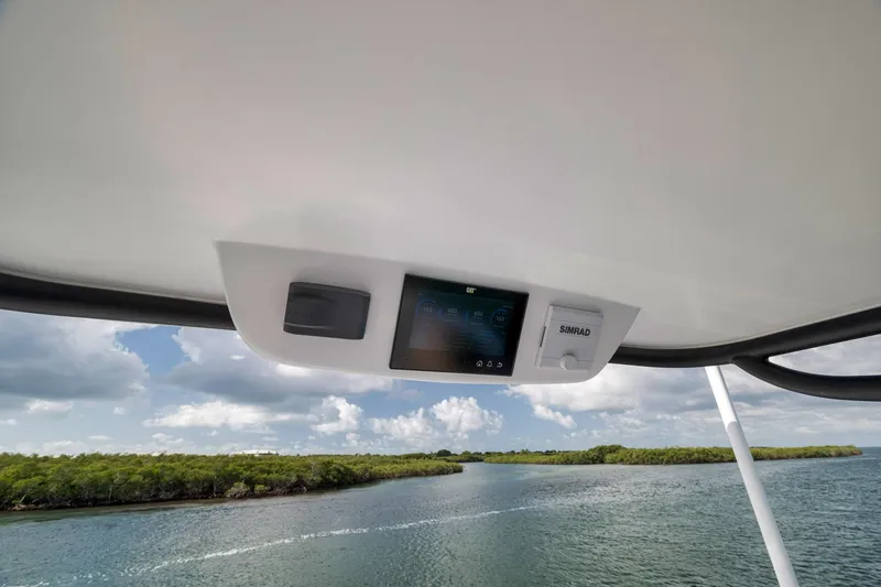 Slide: The Image of 2022 Winter Custom Yachts 38 Walk Around helm with Simrad display, scenic waterway view. - 20