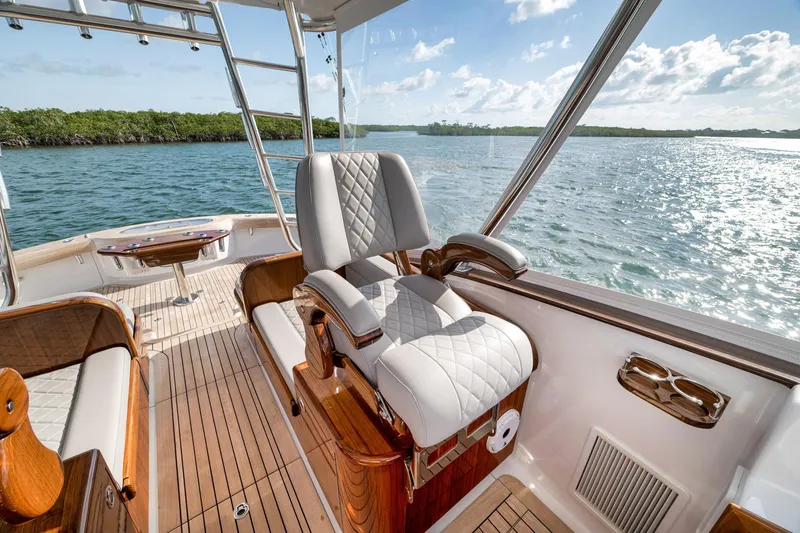 Slide: The Image of Luxurious interior of 2022 Winter Custom Yachts 38 Walk Around, featuring elegant seating and scenic water view. - 21