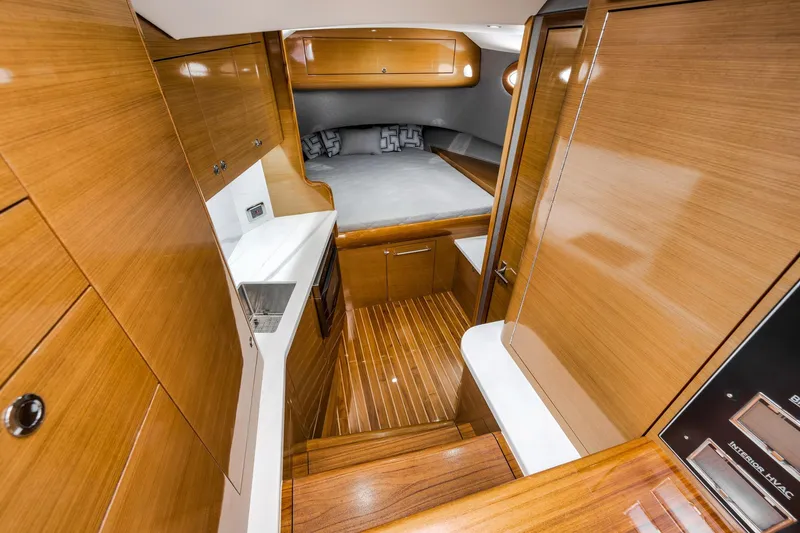 Slide: The Image of Luxurious interior of 2022 Winter Custom Yachts 38 Walk Around, featuring sleek wood finishes and modern amenities. - 23